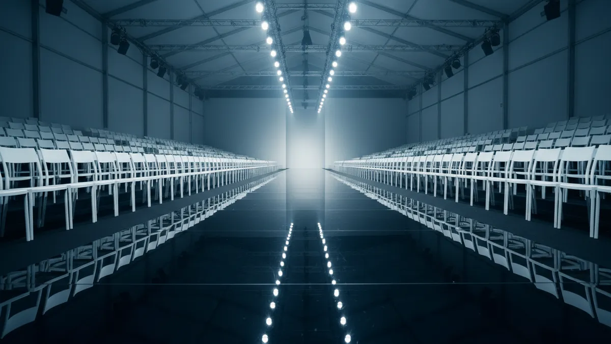 Empty Milan Fashion Week runway venue ahead of September 2026 shows where new CNMI guidelines discouraging fur will take effect